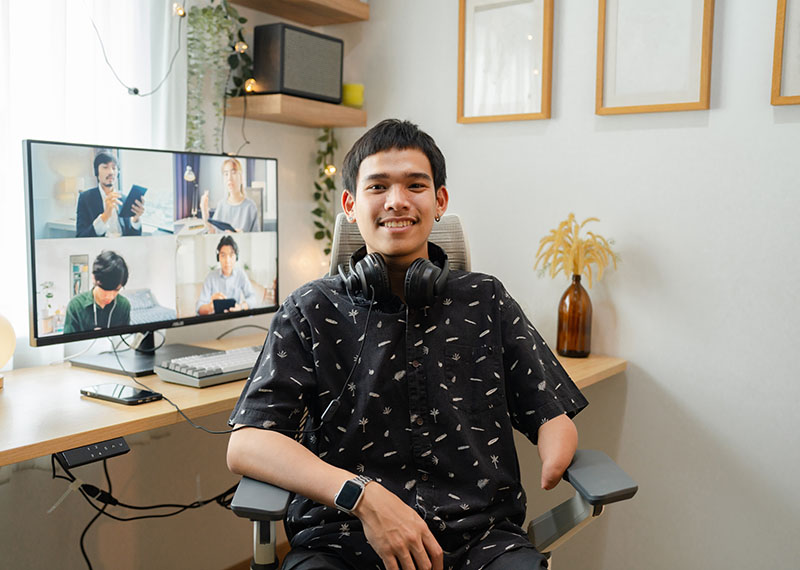 Portrait of disabled businessman sharing ideas with colleagues while working at home