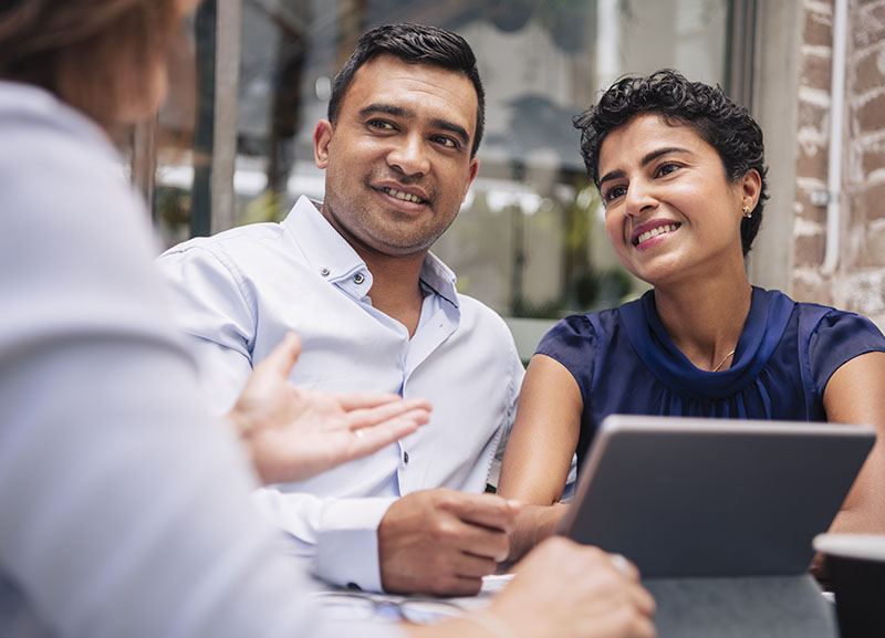 Couple receiving advice from a person.