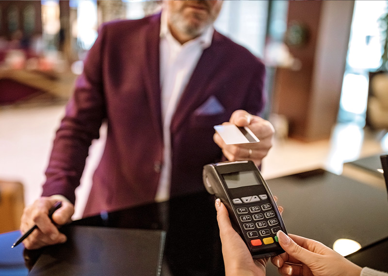 Business person providing their credit card at a hotel