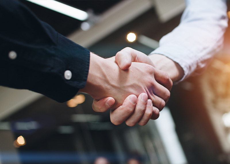 Bussines partners handshakes in modern open space on the background of coworking team on new startup project photo