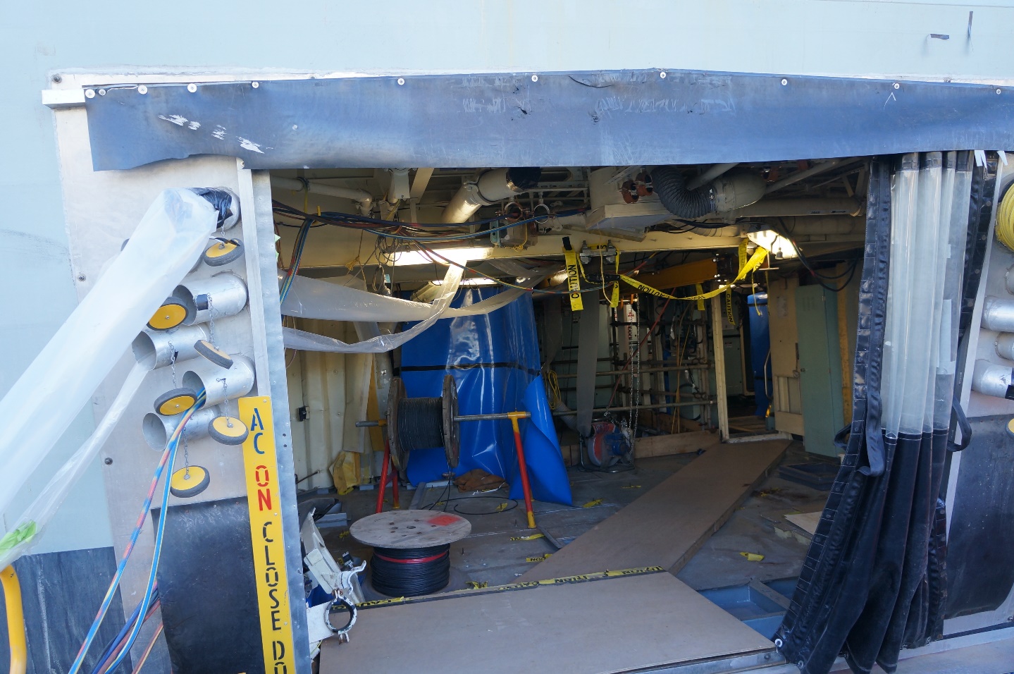 A photograph of ANZAC class frigate HMAS Arunta undergoing maintenance at the Henderson shipyard in Western Australia.