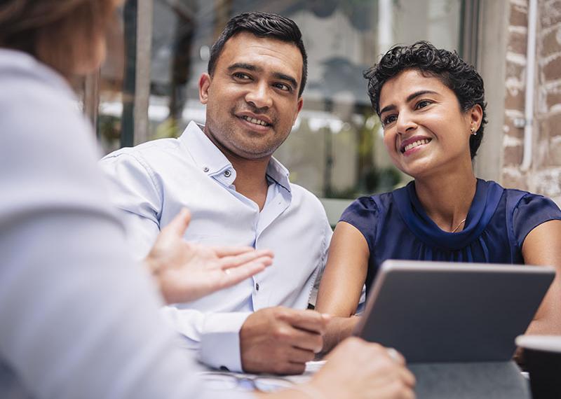 Couple receiving advice from a person.