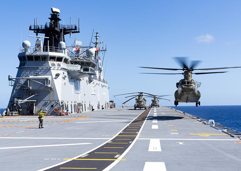 A CH-47 Chinook helicopter takes off from the flight deck of HMAS Canberra