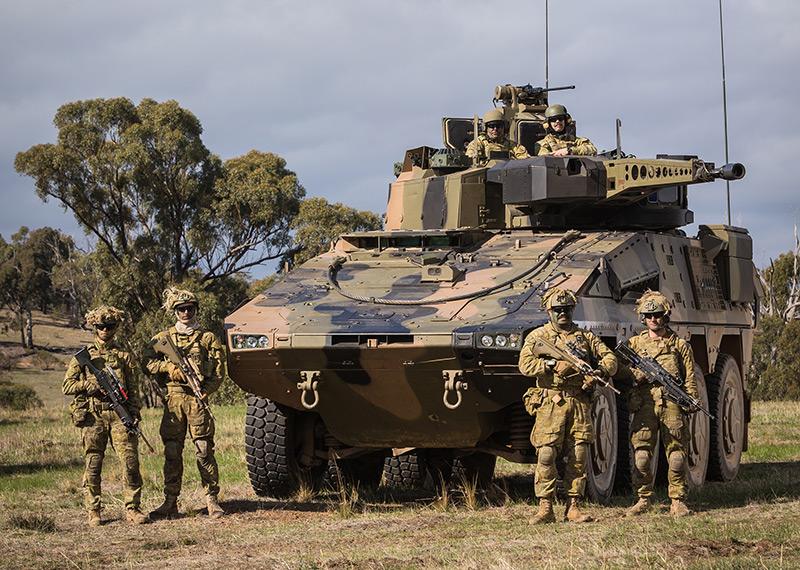 An armoured vehicle with six soldiers